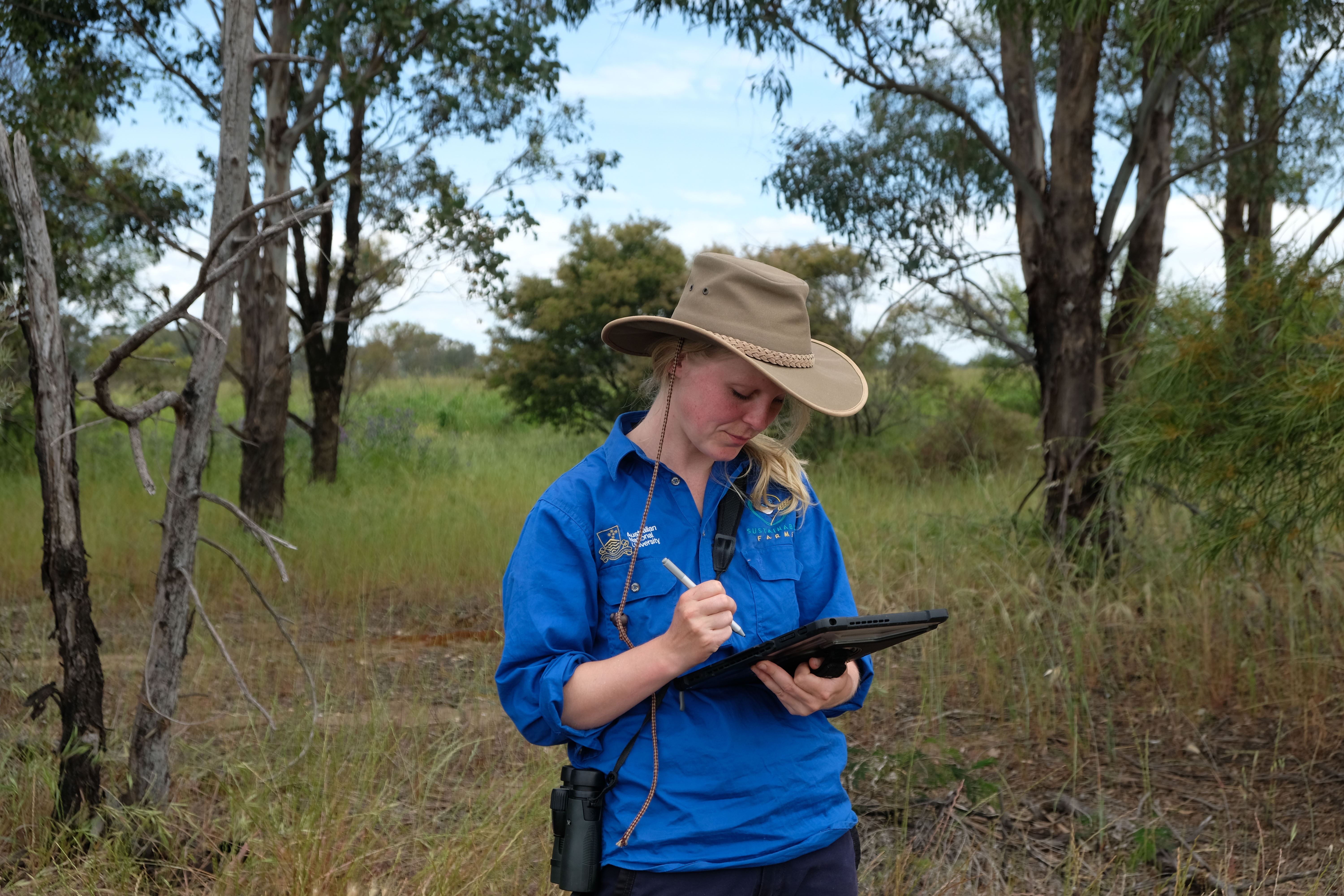 Ecologist using tablet in the field